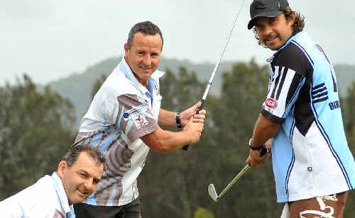 Woolgoolga coach Greg Shuttleworth, kneeling, helps Chris Seymour and Clark Webb prepare for the club’s annual golf day. Woolgoolga coach Greg Shuttleworth, kneeling, helps Chris Seymour and Clark Webb prepare for the club’s annual golf day.